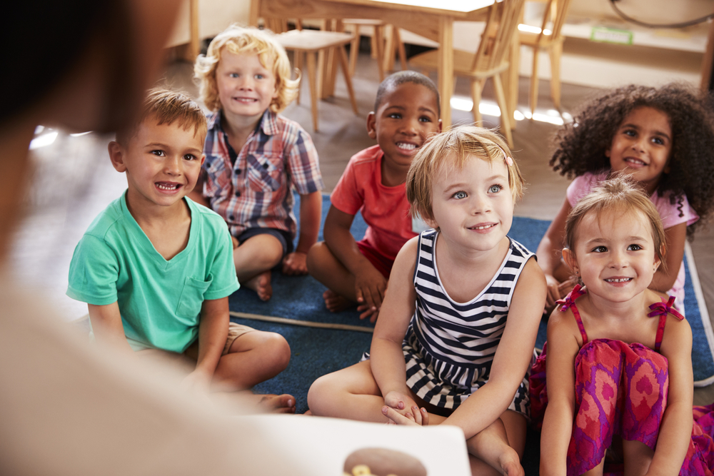 Teacher Reading To Children At Story Time